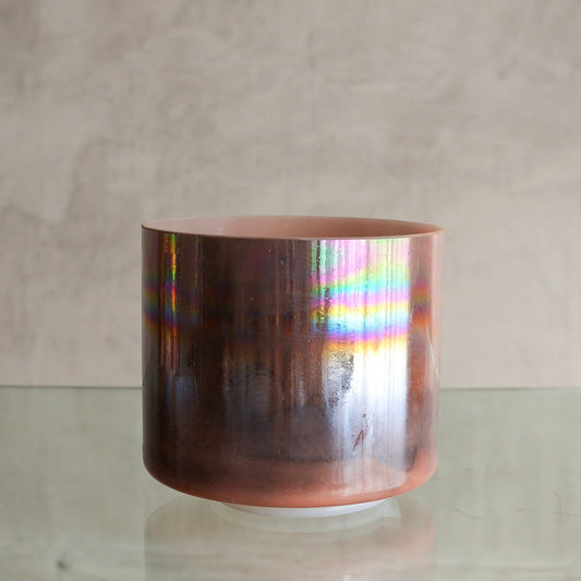 Crystal Tones 7-inch F#-15 crystal singing bowl in Sedona Red Rock, with platinum rim, side view on a glass shelf
