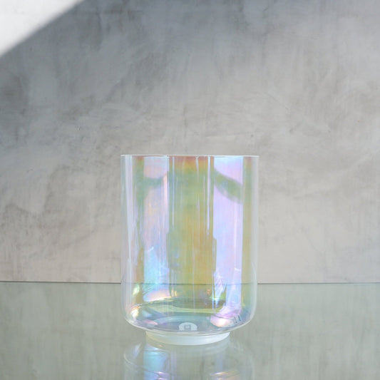 Crystal Tones 7-inch E+15 crystal singing bowl in Platinum Tall and Therapeutic, side view on a glass shelf