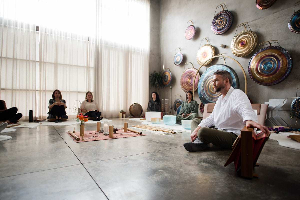 Avery teaching a small group among crystal bowls and gongs in the Los Angeles studio