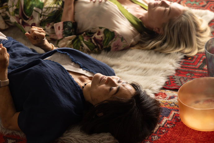 Two Women Lying Down with Eyes Closed Next to Singing Bowls - Immersive Sound Healing Experience for Restoration and Renewal at OSO Sound Healing in Los Angeles